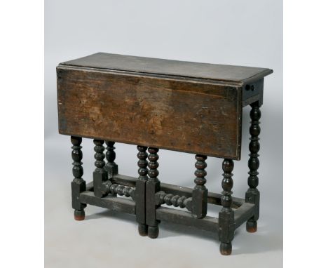 A late 17c/early 18c oak single flap side table of rectangular form, fitted one end drawer, supported on bobbin turned gatele
