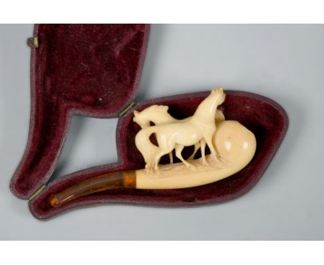 A meersham pipe  carved as two horses with amber mouthpiece, 4.25in l, in leather case.