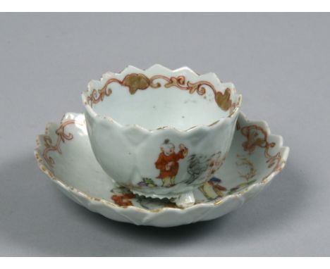 An 18c lotus moulded porcelain teabowl and saucer having chevron shaped borders and painted with figures and goats and suppor
