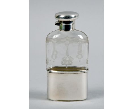 A Asprey &amp; Co pocket flask, the clear glass body with stylistic floral engraved decoration, having a pull off silver tot 