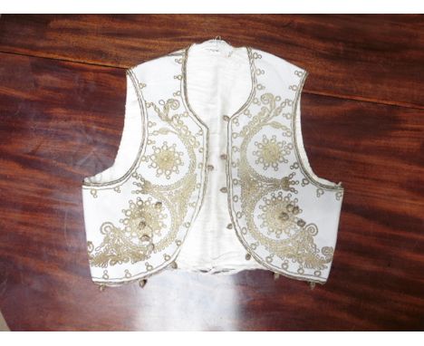 A 19c silk lined cotton waistcoat with gold metallic thread embroidery.