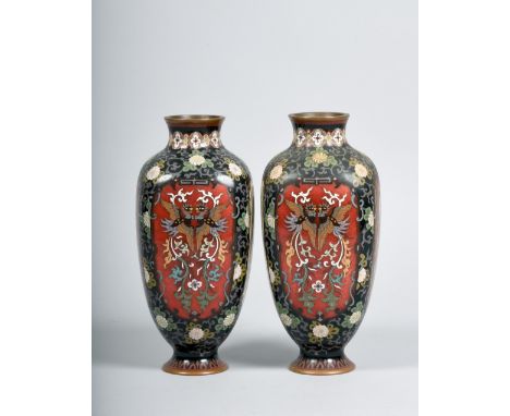 A pair of Meiji period enamel cloisonne vases of quatrefoil baluster form, panel decorated with exotic beasts, each 8.5in h.
