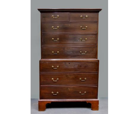 A late Georgian mahogany chest on chest, the upper section of two short and three long graduated drawers under a dentile moul