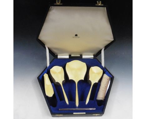 A boxed set of yellow enamel backed and silver brushes and a comb, makers mark for Daniel Manufacturing Co, Birmingham 1932, 