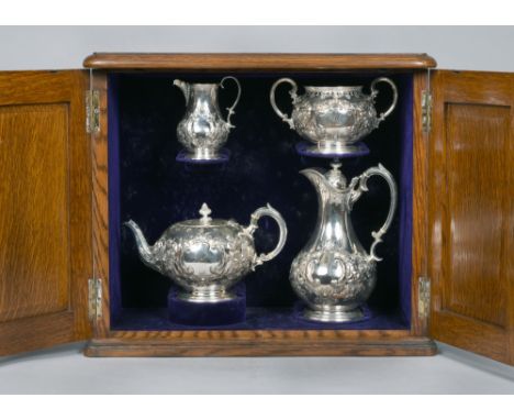 A late Victorian four piece silver tea service, all embossed and chased with scrollwork and flowers, the globular teapot 10.5