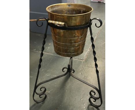 A brass planter on wrought iron stand 