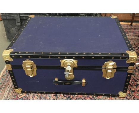 A blue travel trunk with metal corner bracings, 69cmW 