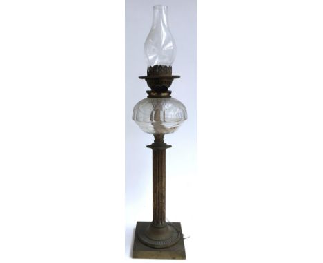 A brass oil lamp on reeded column and square plinth base, cut glass reservoir, with glass chimney, 68.5cmH with chimney 