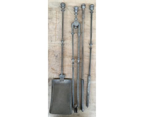 A set of four fire tools: shovel, tongs, and two pokers 