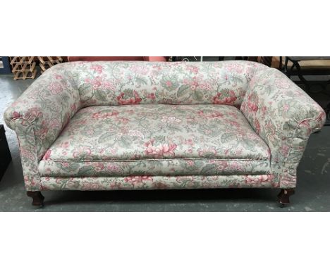 A 20th century drop end sofa upholstered in a floral print 