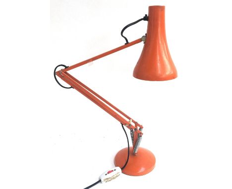 An orange anglepoise lamp 