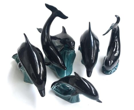 Five Poole Pottery dolphins, of various sizes 