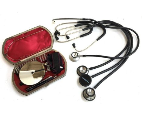 Medical interest: four stethoscopes, together with a cased set of medical tools, with metal plaque inscribed 'St Andrews Univ