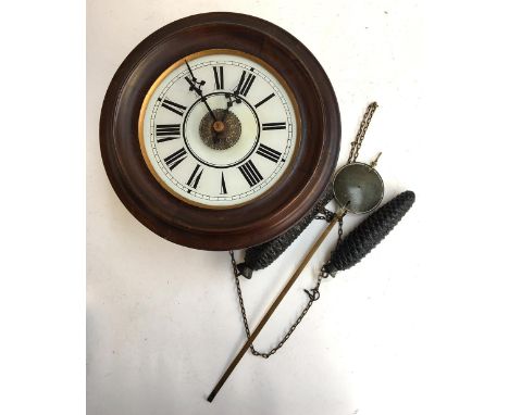 A wall clock, roman numerals to dial 