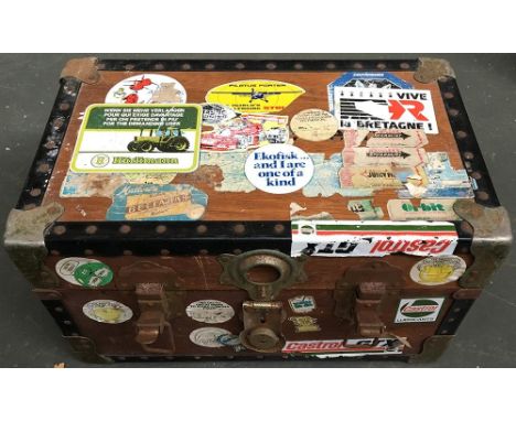 A small wooden chest with metal corners, containing a variety of tools to include a small Stanley wood plane 