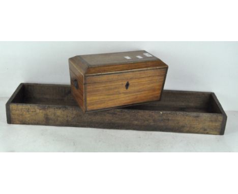 A 19th century wooden box of sarcophagus from, with inlaid borders, 33cm wide; together with a two part wooden trough