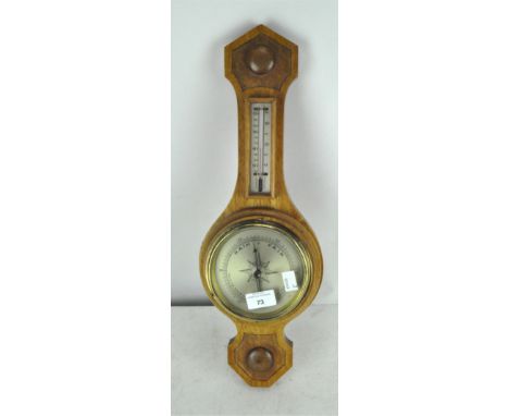 A pale oak wall barometer and thermometer, made in England, 51cm long