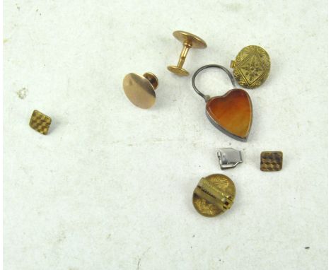A selection of vintage buttons, to include a 9ct gold collar stud, white metal heart locket and more