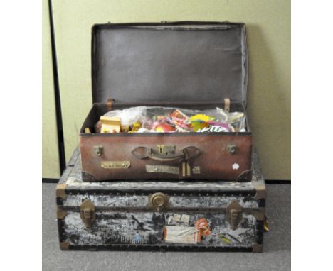 A wooden trunk filled with assorted board games, together with a leather suitcase containing contemporary children's toys