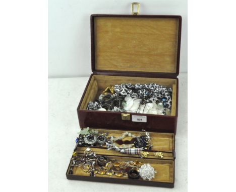 A red leather box containing vintage jewellery, including chains, earrings and more