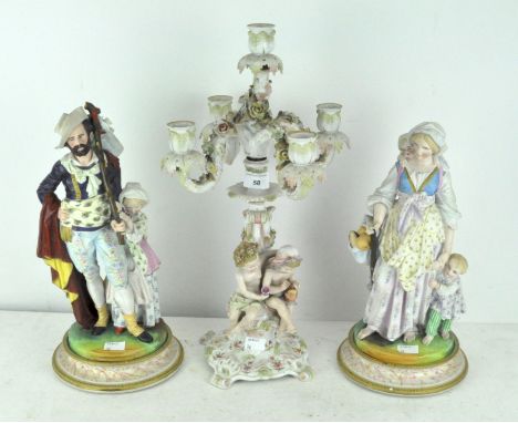 A pair of ceramic late 19th/early 20th century continental depicting a gentleman and lady in period dress, together with a ce