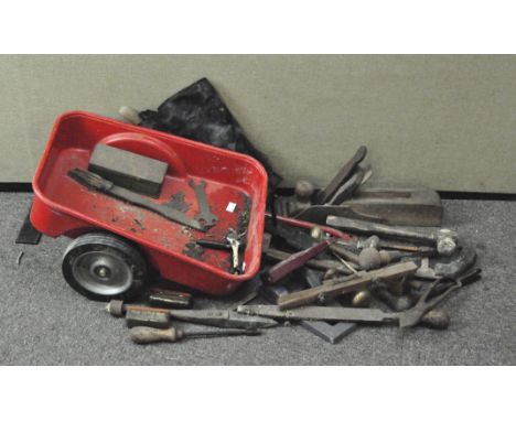 A collection of assorted tools, to include a large plane, saw, hammer and more