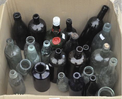 A large quantity of vintage glass bottles, in a variety of colours, sizes and designs, including a Vat 69 whisky bottle with 
