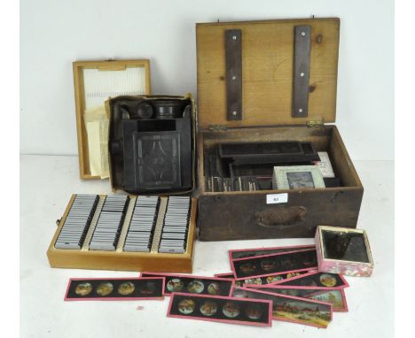 A collection of magic lantern slides, various boxed sets, a tin EP projector and a box of German 35mm slides