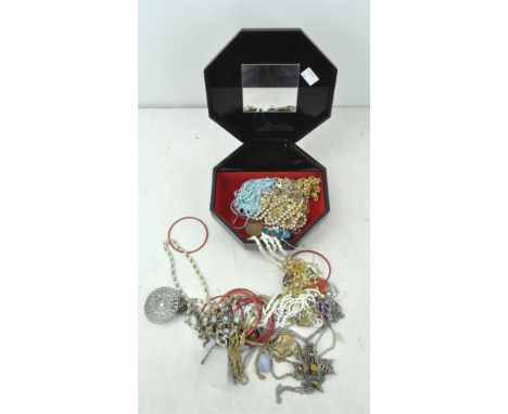 An assortment of vintage costume jewellery, including chains, bangles and other pieces