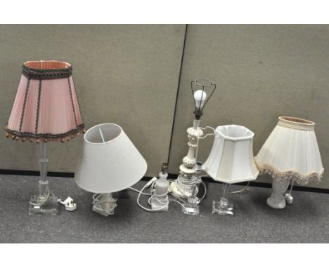 Seven assorted table lamps, including two in marble-onyx, three with glass stands and two wooden examples, some with lamp sha