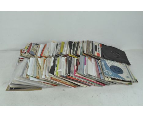 A collection of vintage vinyl singles, including examples by The Beatles, Gene Pitney, Andy Williams and others