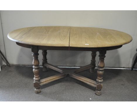 A vintage Ercol style extendable oval dining table,74cm high x 162cm wide x 107cm deep