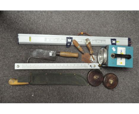 A selection of vintage tools, to include a Machete, bill hook, Rabone &amp; Sons leather bound tape and other tapes