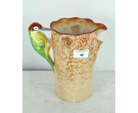 A mid century Royal Falcon ware water jug in the form of a woodpecker on a tree trunk, 20.5cm high