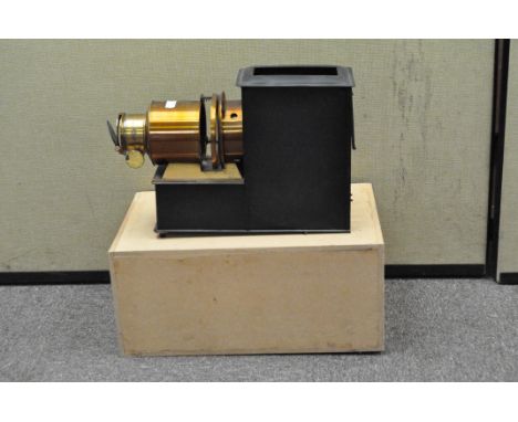 A magic lantern projector, with a brass lens, no makers or retailers marks apparent