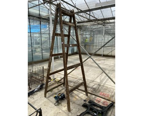 A LARGE WOODEN STEP LADDER 