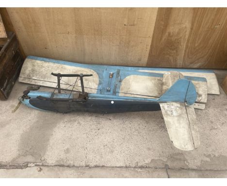 A VINTAGE ENGINE POWERED MODEL BI-PLANE 
