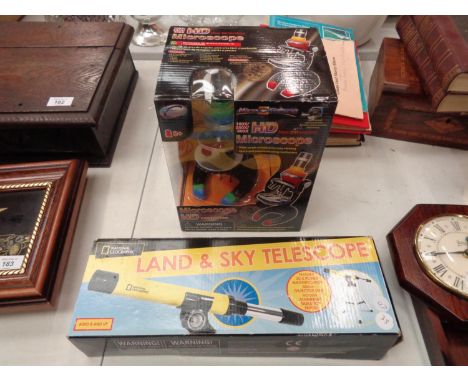 A BOXED NATIONAL GEOGRAPHIC LAND AND SKY TELESCOPE, A BOXED HD MICROSCOPE 