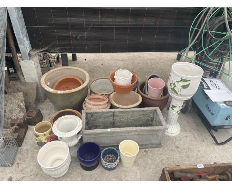 A LARGE ASSORTMENT OF CERAMIC AND STONE WARE POTS AND PLANTERS 