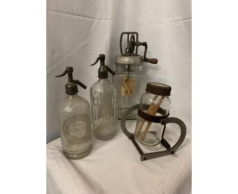 TWO VINTAGE GLASS BUTTER CHURNS TOGETHER WITH TWO VINTAGE SODA SYPHONS, ONE 'CORNWELL'S AERATED WATERS HANLEY' AND FURTHER 'C