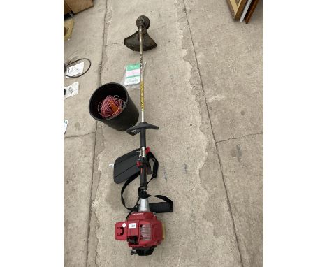 A HIONDA GX22 4 STROKE PETROL STRIMMER WITH A MANUAL AND STRIMMER CORD 