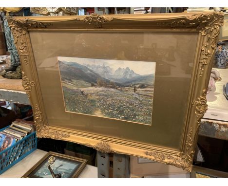 A GILT FRAMED PRINT OF A WOMAN PICKING FLOWERS IN A VALLEY 