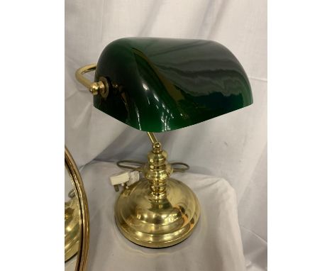 A BRASS FRAMED MIRROR AND A BRASS DESK LAMP WITH A GREEN GLASS SHADE 