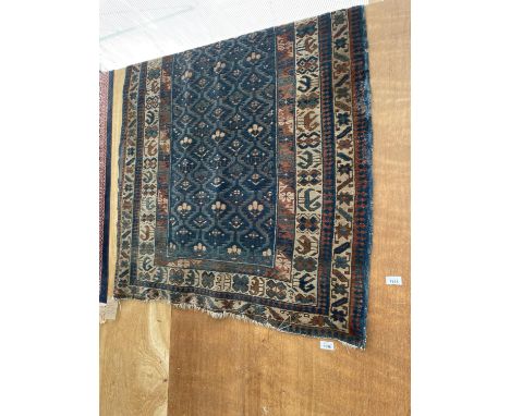 A HAND STITCHED CAUCASIAN VINTAGE PATTERNED WOOL RUG (131CM X 100CM) 