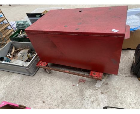 A LARGE METAL TOOL TRUNK WITH A SET OF WHEELS 