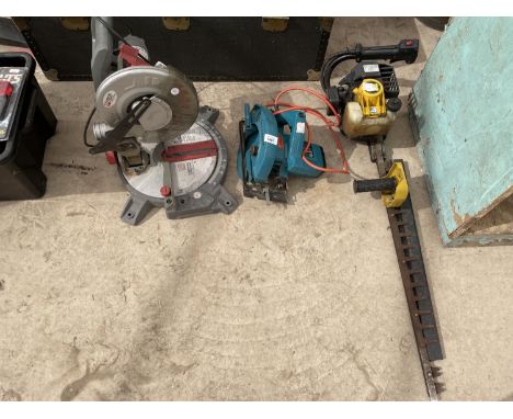 AN ASSORTMENT OF TOOLS TO INCLUDE A PETROL HEDGE CUTTER, MITRE SAW AND A CIRCULAR SAW 