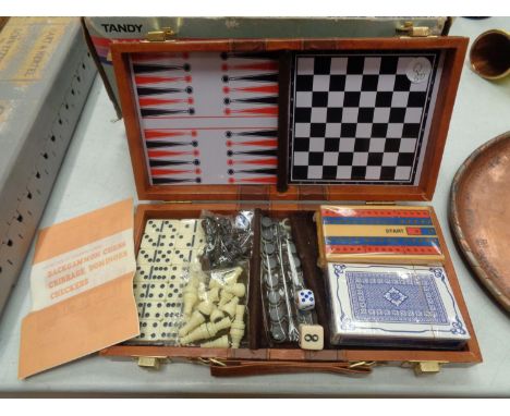 A HINGED BOXED CONTAINING BACKGAMMON, CHESS CRIBBAGE, DOMINOES AND CHECKERS GAMES 