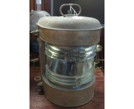 A ship's brass, clear glass mast head lantern. With carrying handle. 43 cm high approx overall.(B.P. 21% + VAT) Heavily tarni