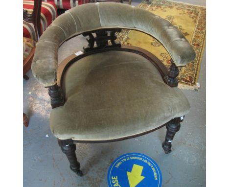 Edwardian tub type library elbow chair with upholstered back and stuff over seat on ring turned legs with brass castors.(B.P.