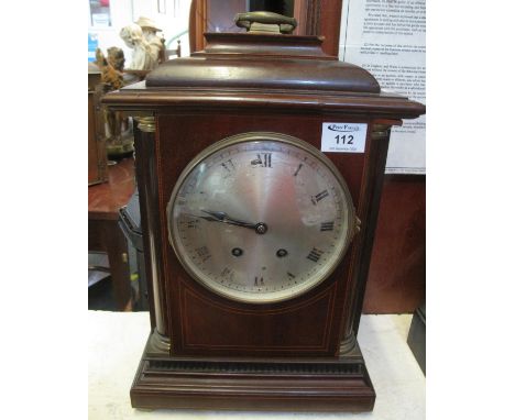 Edwardian, inlaid mahogany two-train bracket clock in Georgian style with stepped top hanging brass handle, the silvered face